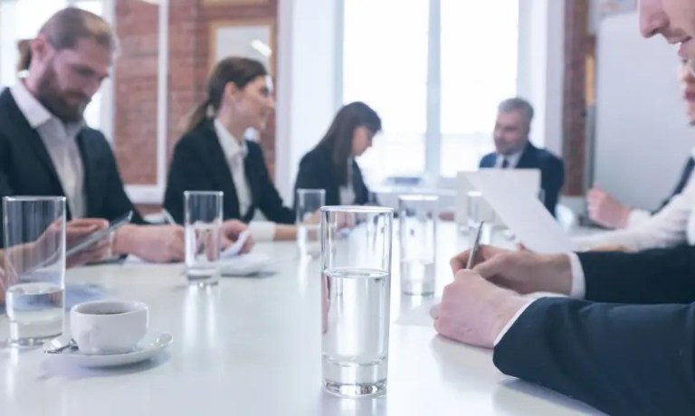 Government professionals drinking glass of water in meeting