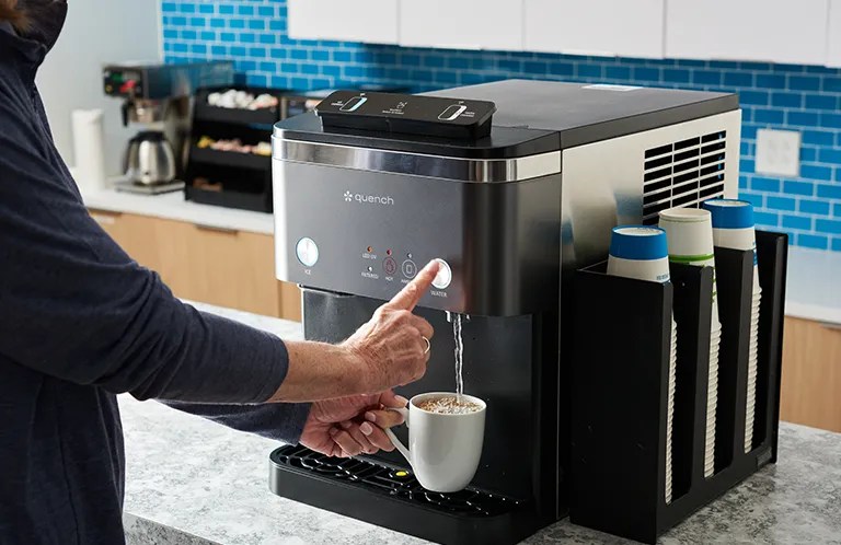 hand dispensing hot water into mug