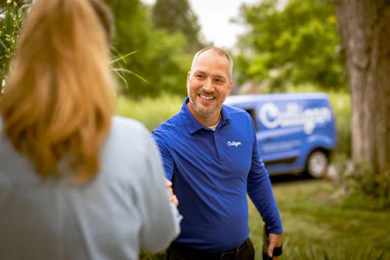Man in blue culligan shirt shaking hand